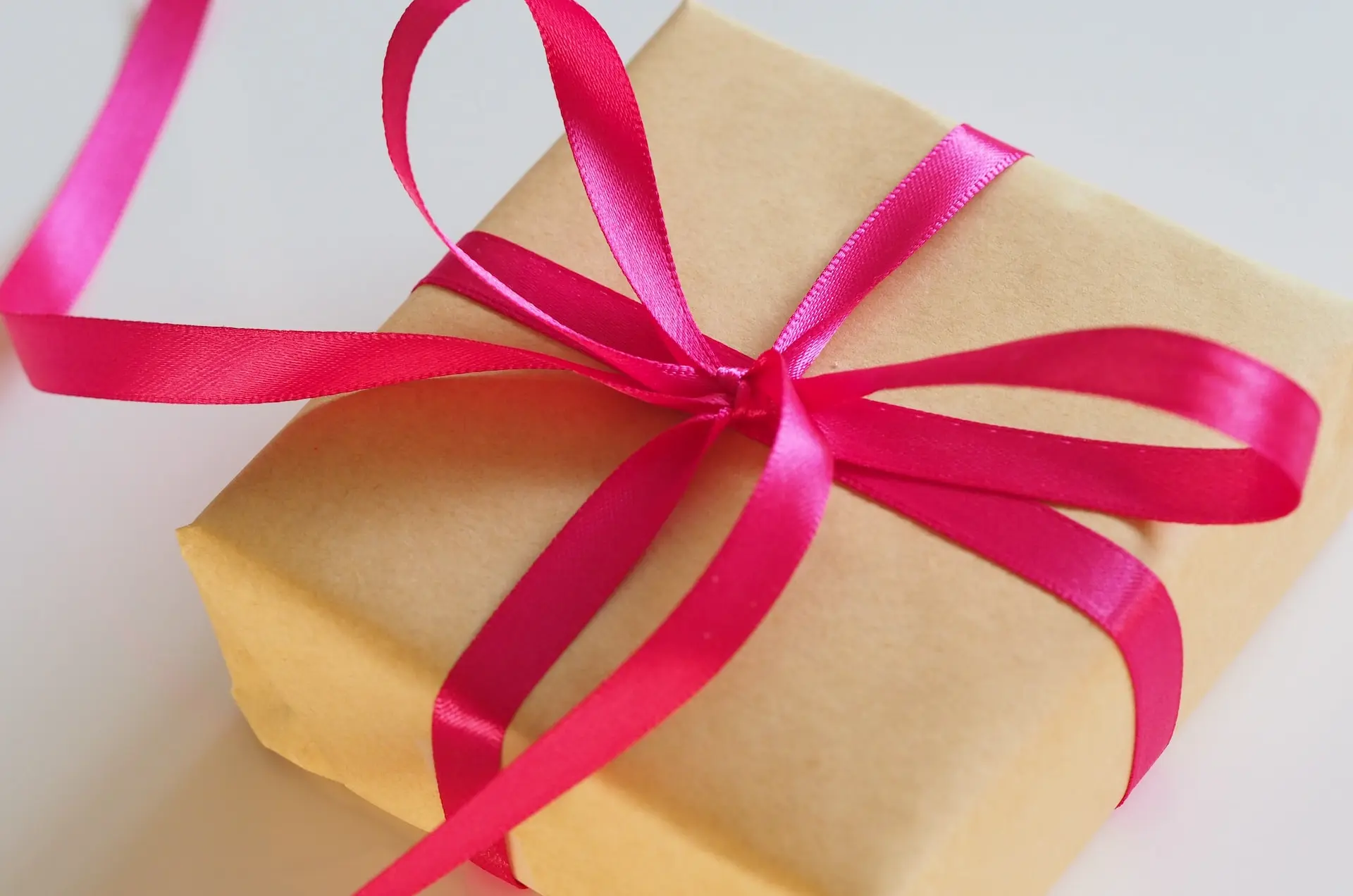 brown gift box with pink ribbon